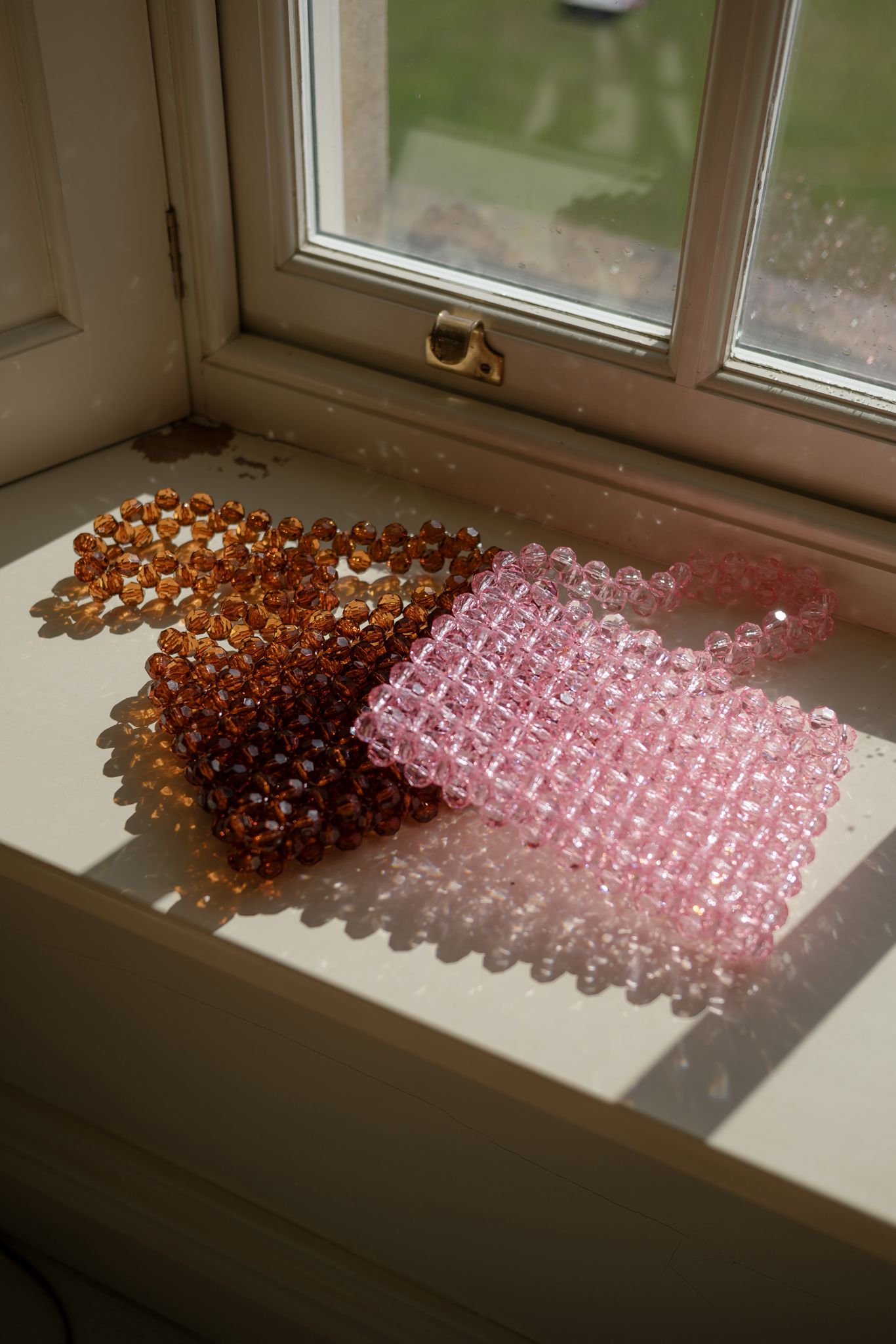 beaded bridal bags on a windowsill 