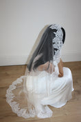 Load image into Gallery viewer, Person wearing a white lace veil sitting on a wooden floor.
