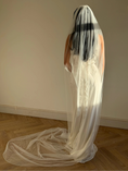 Load image into Gallery viewer, Person wearing a white wedding dress with a long pearl veil against a plain background
