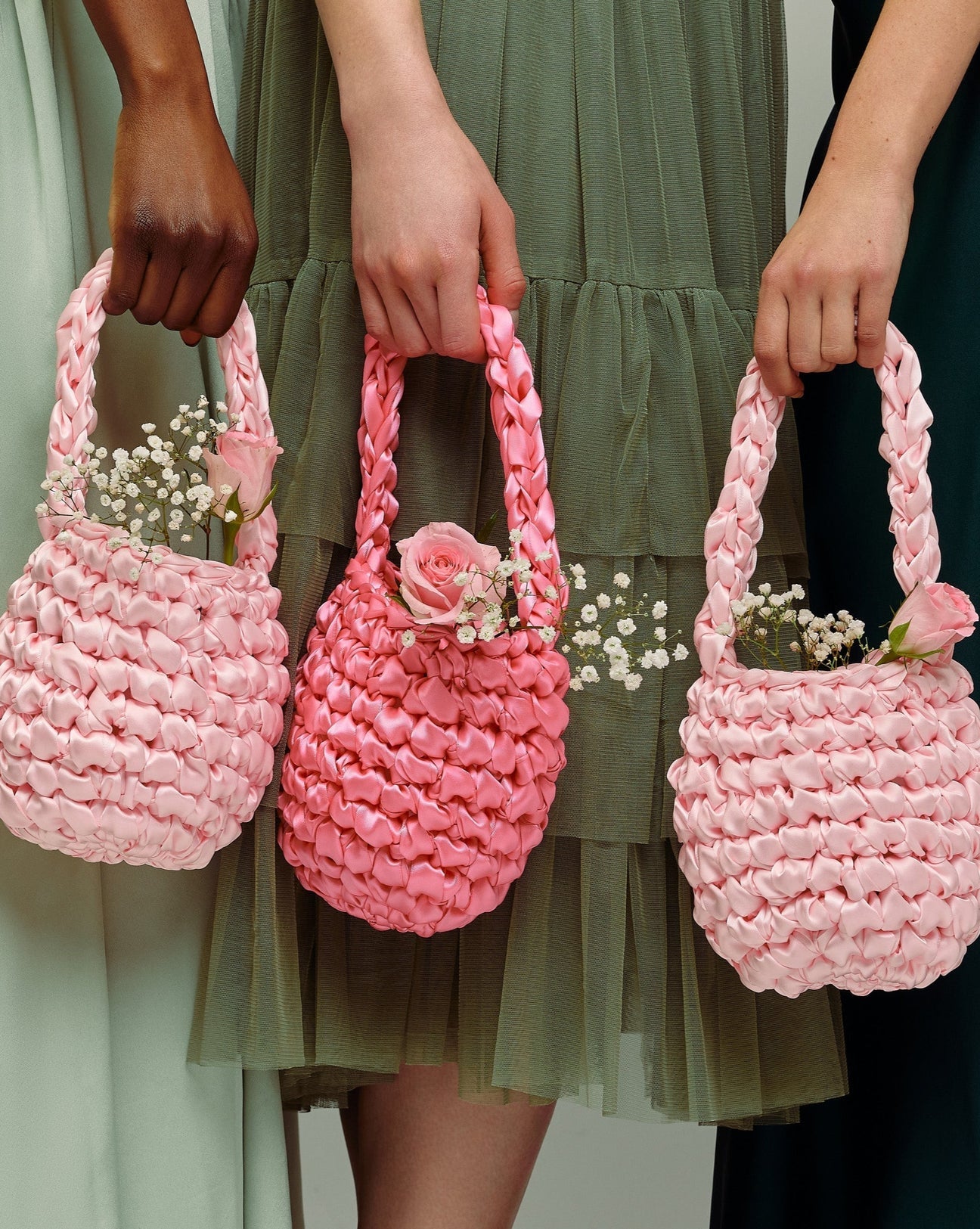 bridesmaids wearing hive bridal handbag in blossom