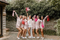 Load image into Gallery viewer, bride and bridesmaids wearing hive bridal handbag in red, blossom and hot pink
