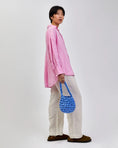 Load image into Gallery viewer, woman holding hive bridal handbag in wisteria
