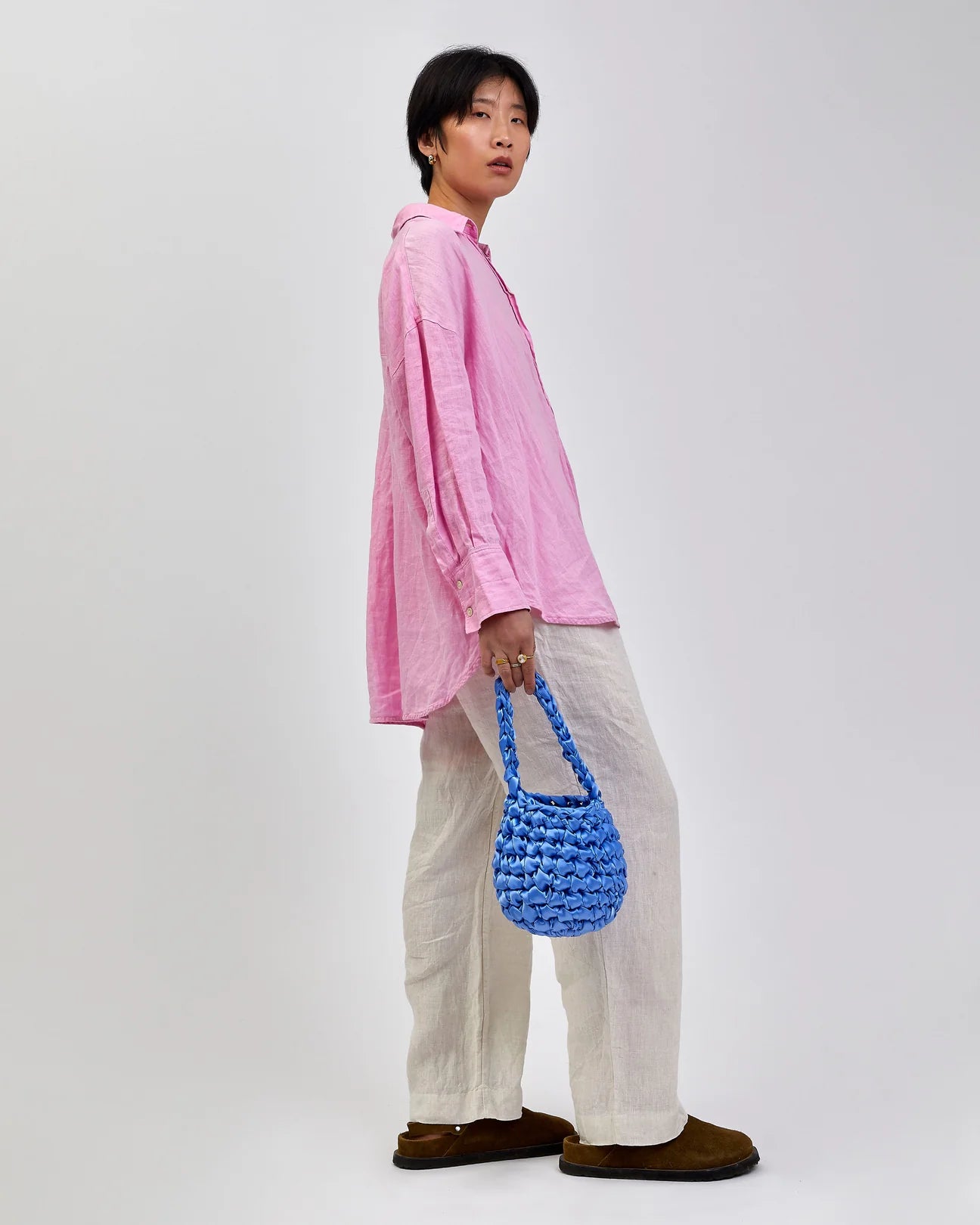 woman holding hive bridal handbag in wisteria