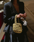 Load image into Gallery viewer, woman wearing hive metallic bridal handbag in gold
