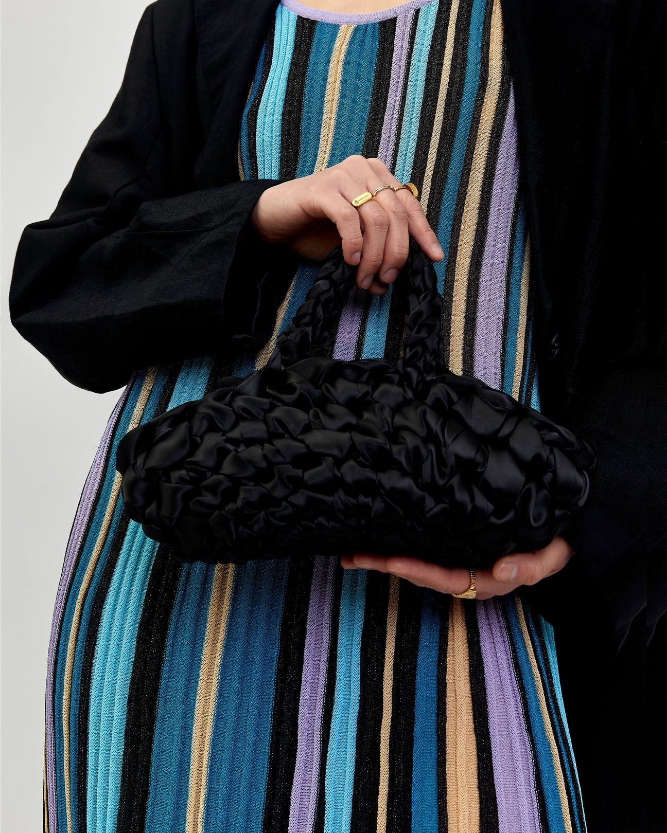 woman holding nest bridal handbag in black