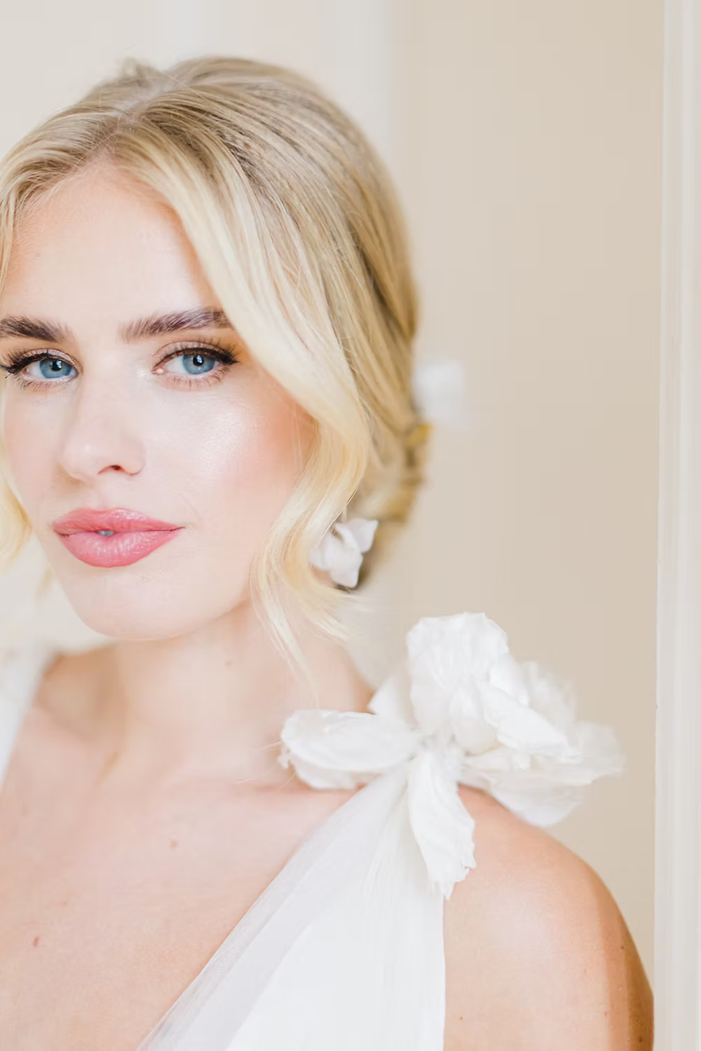 bride wearing a wedding dress and sill flower bridal earrings