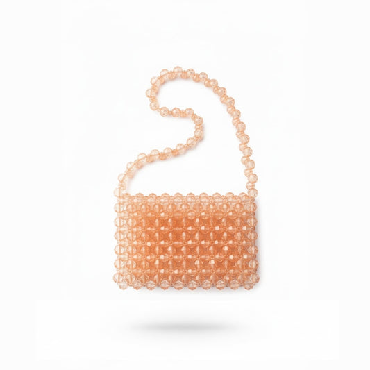 Peach-colored beaded bridal bag on a white background
