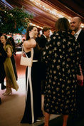 Load image into Gallery viewer, Woman in a black and white dress interacting with a man in a patterned coat at an event wearing bridal bag
