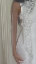 Load and play video in Gallery viewer, Model wearing White lace veil and wedding dress on a wooden floor with a plain white wall background
