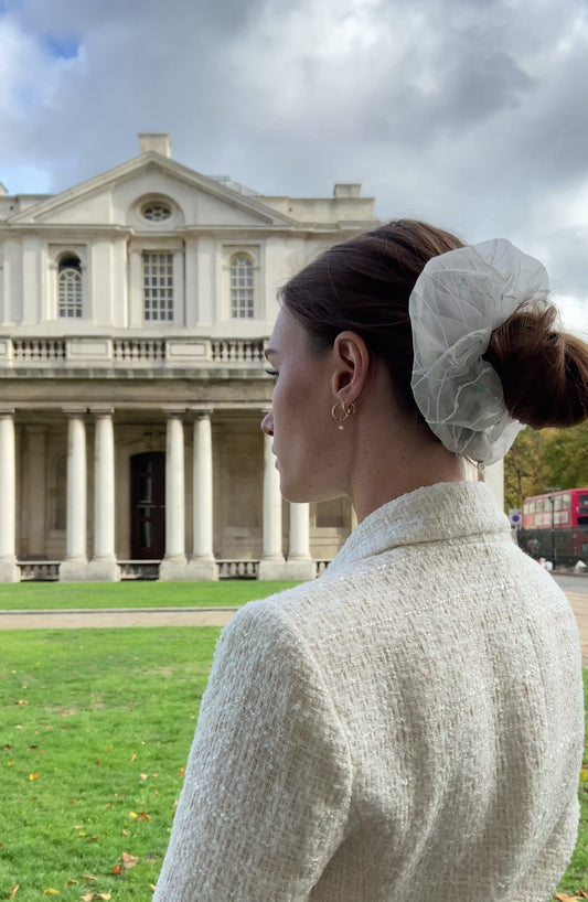 girl in an outdoor setting wearing a white bridal hair scrunchie