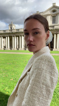 Load and play video in Gallery viewer, woman in outdoor setting wearing a white bridal hair scrunchie
