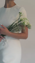 Load and play video in Gallery viewer, Woman wearing a white bridal headband against a light grey background
