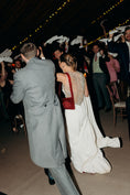 Load image into Gallery viewer, Wedding couple dancing with guests in formal attire at a reception wearing bridal bag
